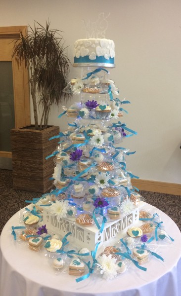 Turquoise and purple themed cookie and cake tower